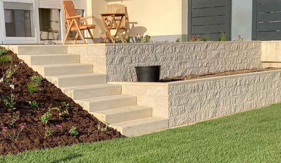 Stützmauer mit Stackton in Retroweiß gebaut für eine Terrassenabgrenzung